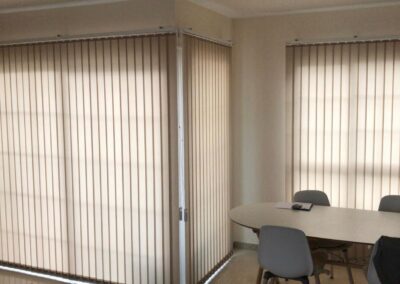 Interior vertical-slat blinds installed next to a large window in Tenerife