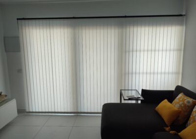 Custom-made vertical blinds for light and privacy control in a living room in Tenerife