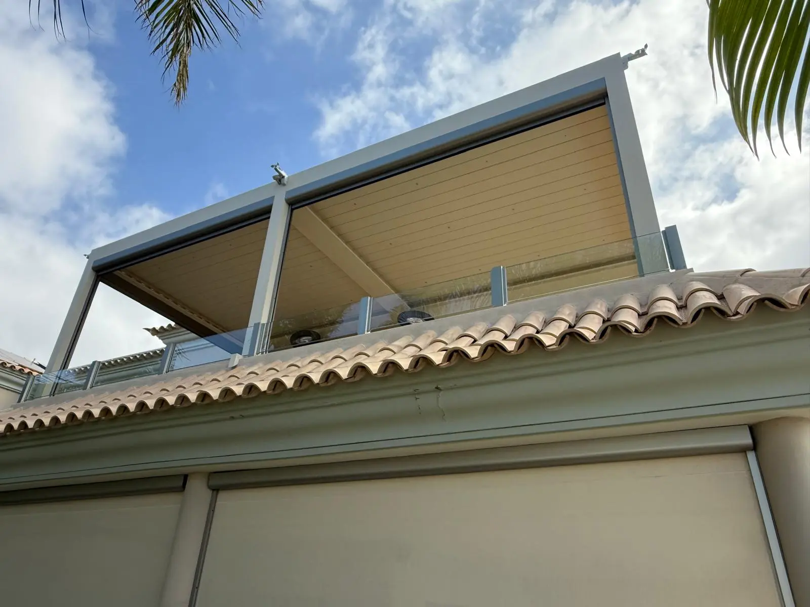 Brown bioclimatic pergola installed in an outdoor area
