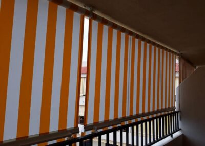 Toldo vertical de lona a rayas instalado en un balcón en Tenerife